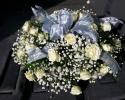 These bridal flowers are one our latest designs. White roses and baby breath with a hint of ribbon create a classic wedding bouquet style. 